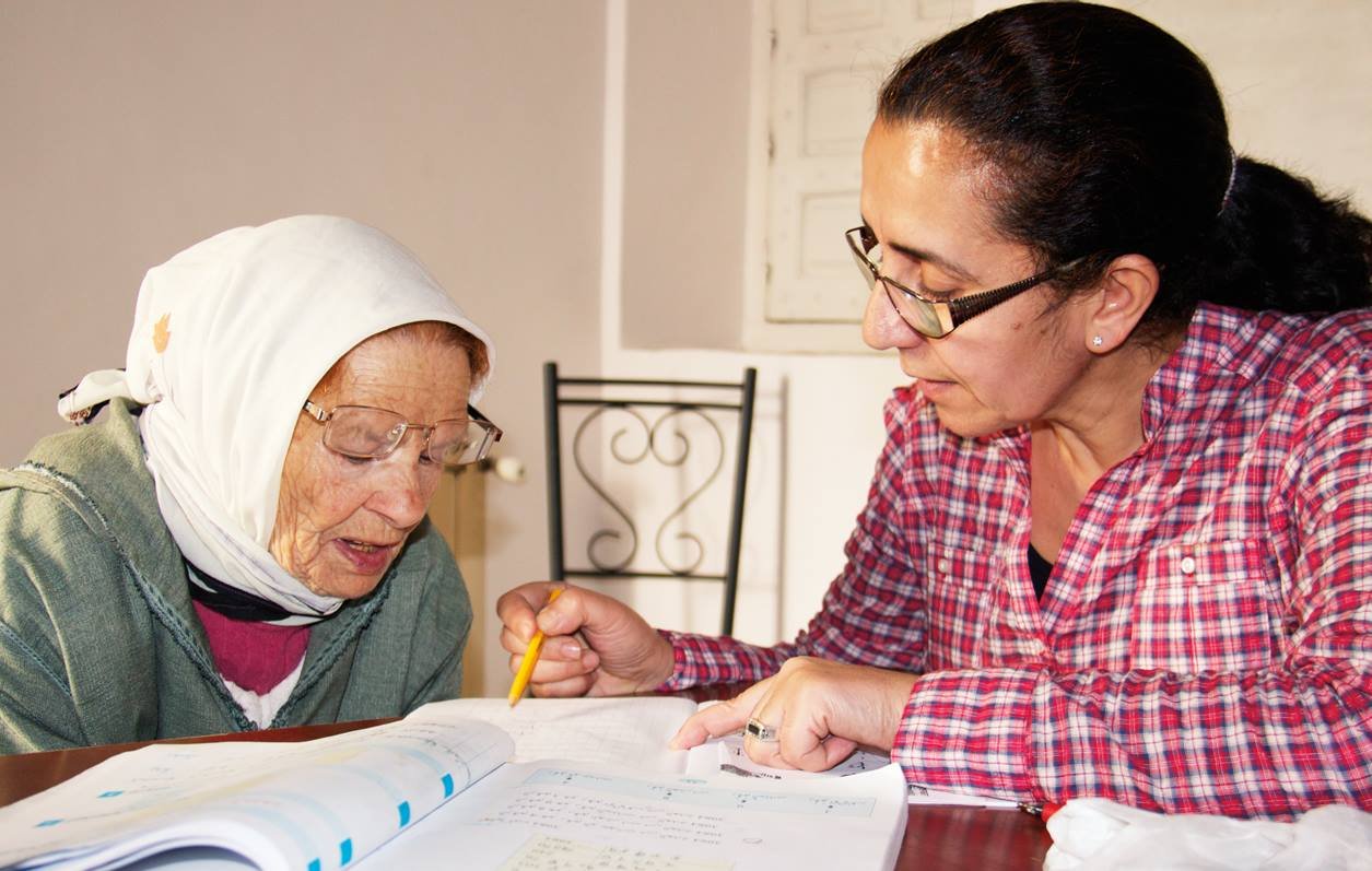 Teacher helping a literacy participant